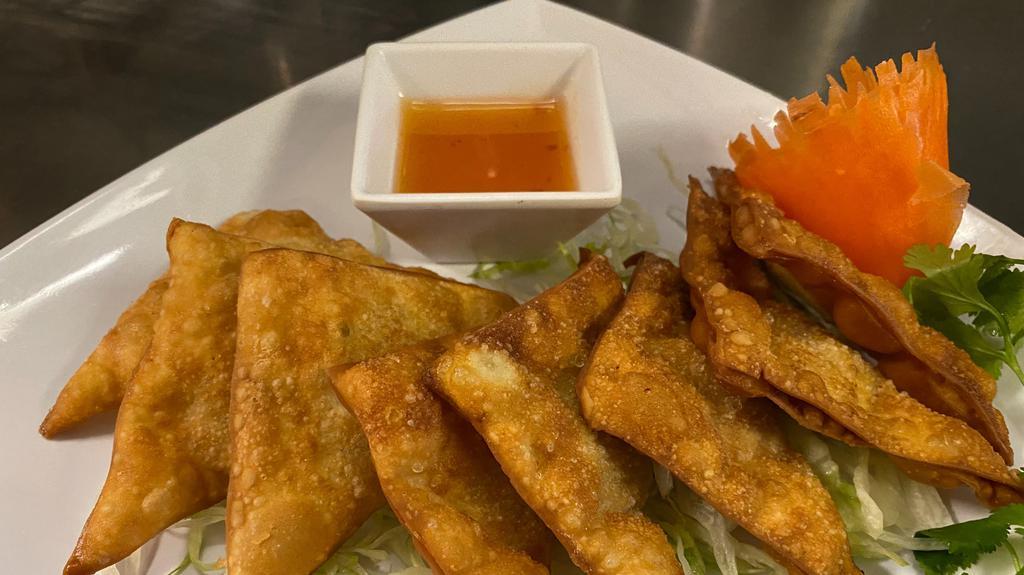 8 Piece Chicken Fried Wonton · Ground chicken marinated with salt and pepper wrapped in wonton shells. Served with sweet and sour sauce.
