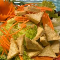 House Salad · Mixed green salad with bean curd, raisins, and peanut dressing.