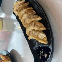 Pot Stickers · Dumplings filled with chicken and vegetables, deep fried, served with a black vinegar dippin...