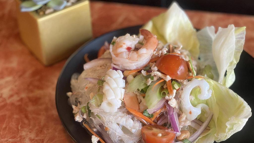 Yum Woon Sen | Glass Noodle Salad · Glass noodles with squid, prawns, minced chicken, chopped vegetables, fresh herbs and lime dressing.