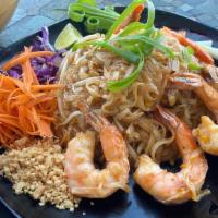 Phad Thai (Gf) · Thin rice noodles wok fried with egg, bean sprouts, and green onions, topped with sliced car...