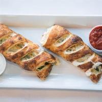 Meat Stromboli · Our pizza dough wrapped around loads of cheese, pepperoni, Beef, Salami. Served with either ...