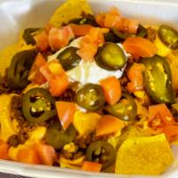 Nachos Supreme · Corn chips, taco beef, sour cream, cheese, tomato and jalapenos with salsa.