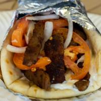 Steak Gyro · Steak, tomatoes and onions in a pita bread with tzatziki sauce. Served with french fries.