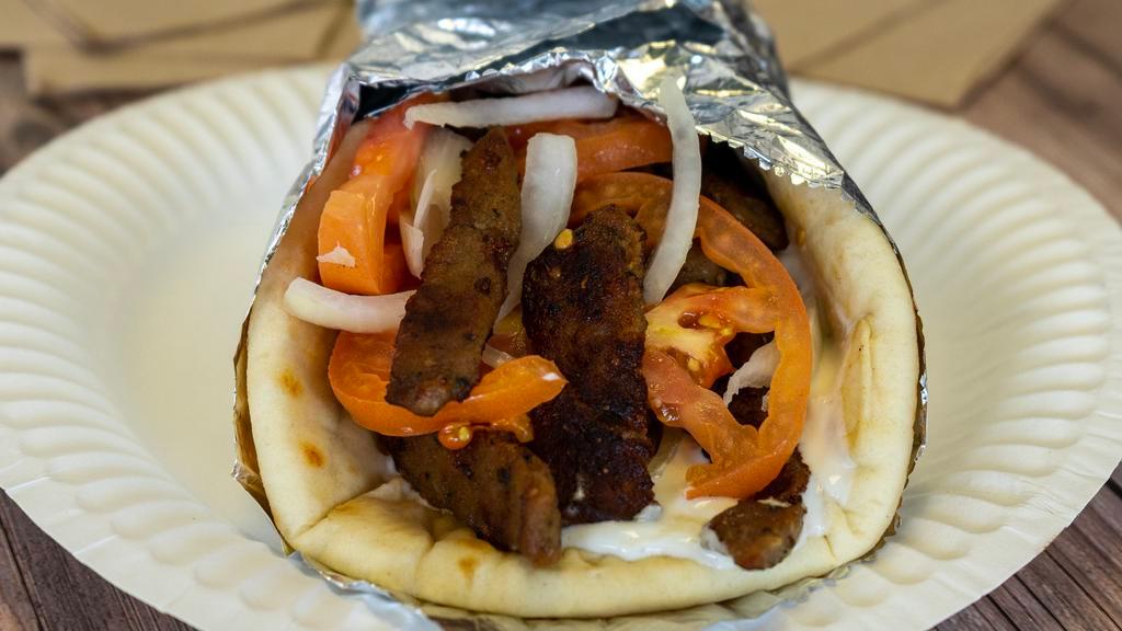 Steak Gyro · Steak, tomatoes and onions in a pita bread with tzatziki sauce. Served with french fries.