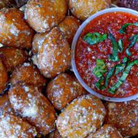 Garlic Parm Knots · Golden fried dough knots tossed in garlic butter & parmesan and. served with a side of red s...
