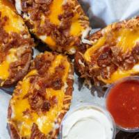 Loaded Potato Skins Platter · Deep fried potato skins, topped with three cheeses and bacon bits, served with sour cream.