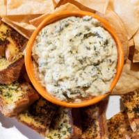 Spinach Artichoke Cheese Dip · Our own, made from scratch, served with our fresh made tortilla chips, or garlic bread.