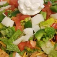 Chili Nacho Platter · Our homemade tortilla chips, topped with our famous chili, shredded cheddar, lettuce, diced ...