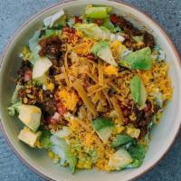 Crunchy Taco Salad · ground beef, black beans, avocado, tomato, roasted corn, cheddar cheese, pasilla ranch dress...