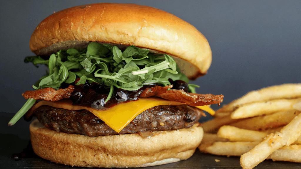 Big Sky Bison Burger · Hand-pressed bison burger, cheddar cheese, hickory-smoked bacon, huckleberry-jalapeño BBQ sauce & baby arugula. Served with fries. )cal 1750)
