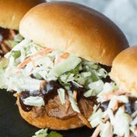 Pulled Pork Sliders · Smoked pulled pork with jalapeño-huckleberry BBQ sauce & house coleslaw on mini brioche buns...