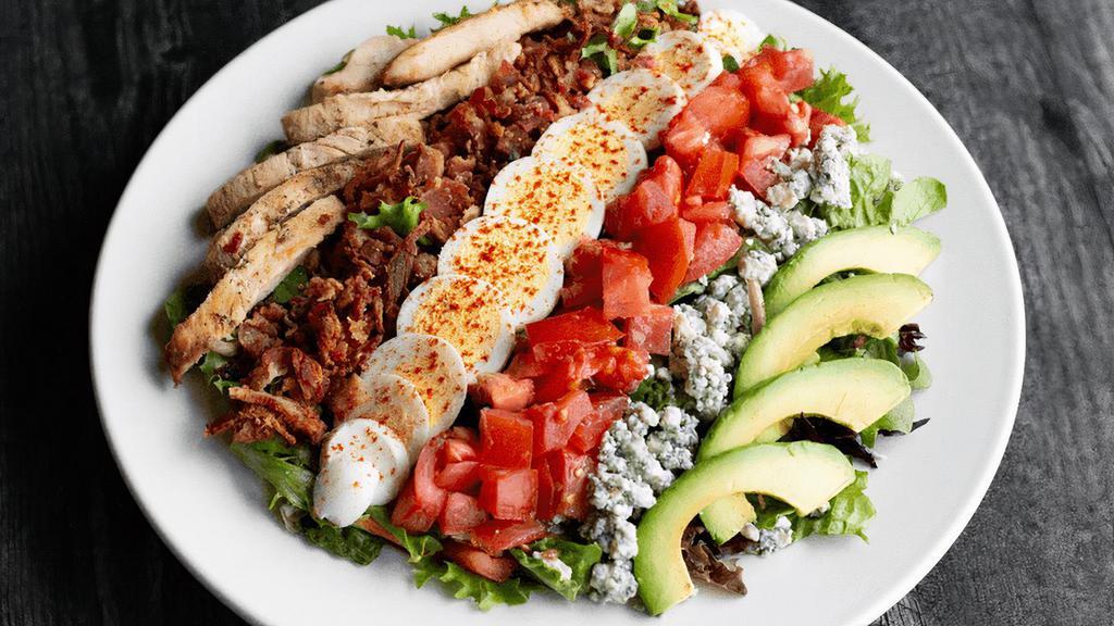Cobb Salad · 12-16 SERVINGS. Fajita chicken, avocado, bacon, hard-boiled eggs, tomatoes & crumbled bleu cheese over crisp greens. (cal 230-270/serving)