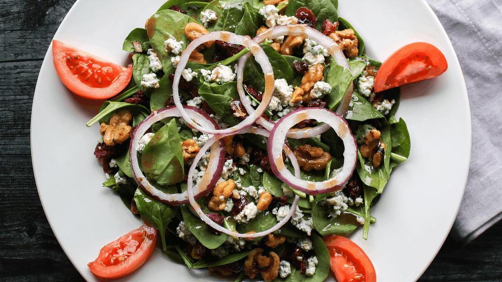 Spinach · Spinach, tomatoes, red onions, candied walnuts, dried cranberries & bleu cheese crumbles. Served with our house vinaigrette.