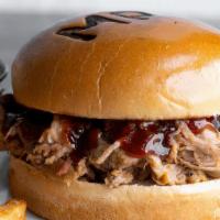 Pulled Pork · Smoked pulled pork with bourbon BBQ sauce & house-made coleslaw on a brioche bun. Served wit...