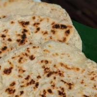 Coconut Roti · One piece of pol (coconut) roti -- a thick flatbread made with grated coconut in the dough.
...