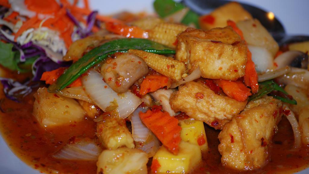 Tropical Sun Madness · Slices of mango, pineapple chunks, onions, snow peas, carrots, baby corns, mushroom, chopped lemongrass, and fried tofu in chef's special vegetarian sweet and sour sauce.
