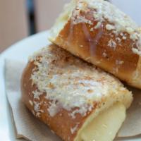 Cheese Roll (Enroladinho De Queijo) · Vegetarian. Soft roll filled with mozzarella and glazed with coconut.