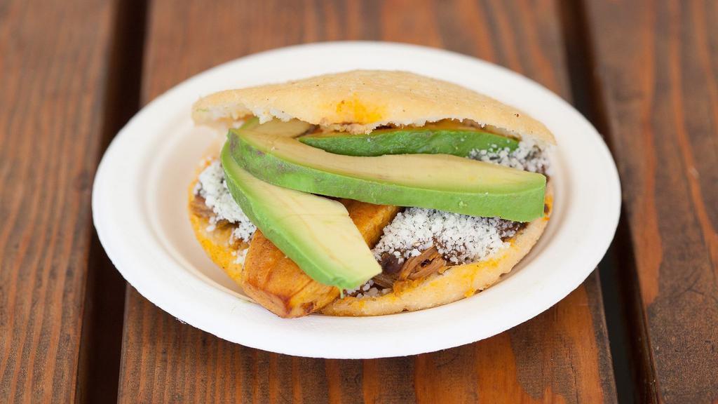 Pabellón Arepa (Chicken) · Shredded beef, fried plantain, black beans, avocado, and grated white cotija cheese.
