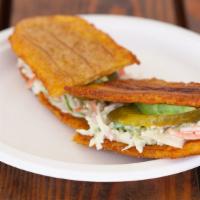 Patacón · A delicious sandwich made with two thin crispy slices of fried green plantain instead of bre...