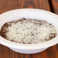 Caraotas & Queso Blanco · Black beans and cotija cheese.