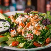 Buffalo Chicken Salad · Prices vary in store.  Fresh romaine topped with grilled Buffalo chicken strips, bacon, Parm...