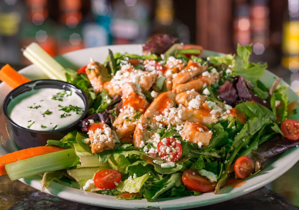Buffalo Chicken Salad · Prices vary in store.  Fresh romaine topped with grilled Buffalo chicken strips, bacon, Parmesan cheese with Buffalo and bleu cheese dressing. Spicy.