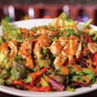 Thai Chicken Salad · Fresh greens layered with Red Bell Peppers & Grilled Chicken, topped with Crushed Peppers, C...