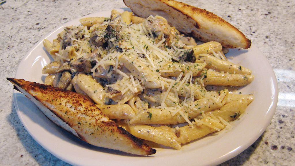 Steak Strip Alfredo · Tender mesquite beef strips and pan-fried mushrooms with penne pasta finished with our creamy Alfredo sauce and Parmesan cheese.
