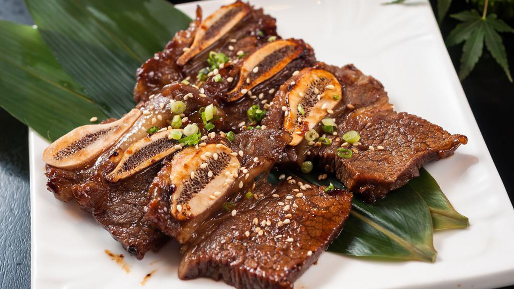 Beef Short Ribs (Kalbi) · Juicy grilled beef short ribs (kalbi) served with steamed rice and salad!