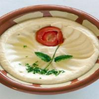 Hummous Appetizer · Freshly mashed garbanzo beans with garlic, tahini sauce, lemon juice topped with olive oil a...