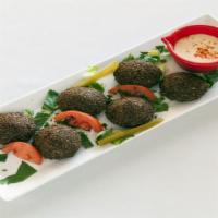 Falafel Appetizer · Combine crushed chickpeas, mashed garlic, special spices and the searing heat of boiling oil...