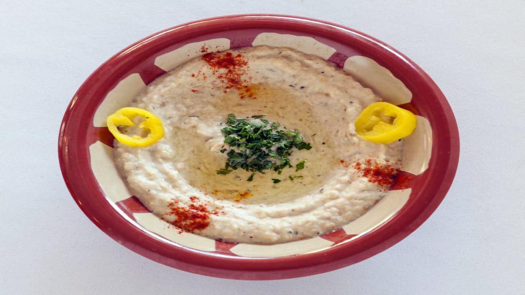 Baba Ghanouj Appetizer · Freshly baked and mashed eggplant with garlic tahini sauce, lemon juice topped with olive oil and chopped parsley. Vegan, vegetarian and gluten free.