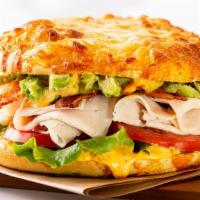 Hotel California · A fresh-baked 6-cheese artisan roll topped with turkey, thick-cut bacon, smashed avocado, le...