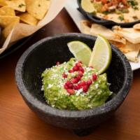 Holy Guacamole! · Fresh Avocado, Pomegranate, Cotija, Lime, Salsa with Corn Tortilla Chips