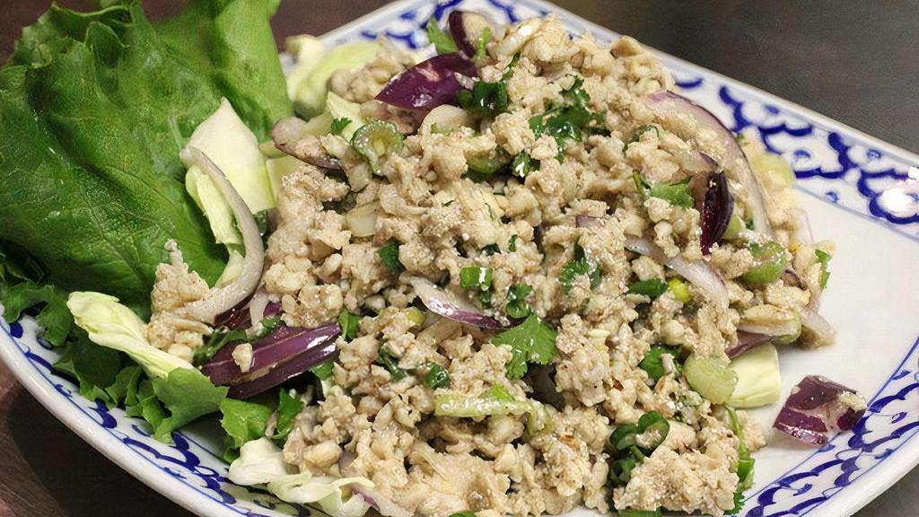Larb · Ground meats, seasoned and flavored with roasted ground sticky rice, lime juice, cilantro, onion, mint, and chili powder served with cabbage.