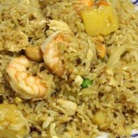 Pineapple Fried Rice · Fried rice with prawns, chicken and egg mixed with pineapple, carrots, peas, tomatoes, raisi...