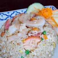 Chili Thai Fried Rice · Fried rice with prawns, chicken, pork, egg, tomatoes, raisins, carrots, peas, and onions. Se...