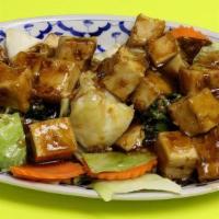 Garlic Tofu · Fried tofu with fresh garlic and peppers sauce on top of steamed vegetables.