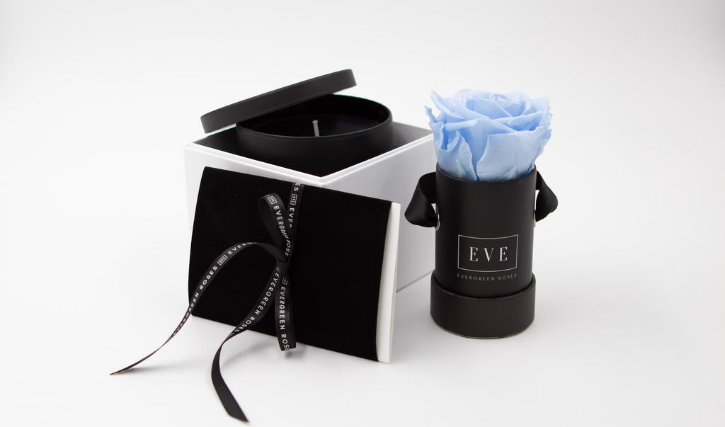 Gift Box With Blue Rose And Fragrant Candle · Our Premium Preserved Roses along with a beautiful and fragrant hand-poured candle tumbler will make her day! Delivered in a branded gift box. Includes: 1. The Hummingbird Arrangement (Blue Premium Preserved Rose in a box); 2. 11oz fragrant candle in an elegant glass tumbler.