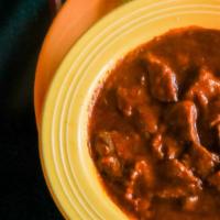 Bowl Of Chile · Piping hot bowl of Red or Green Chile Beef or Green Chile pork served with a flour tortilla.