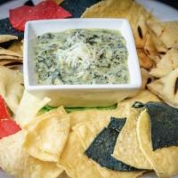 Spinach & Artichoke Dip · Roasted artichoke, creamy spinach and brie dip with tortilla chips and grilled flatbread.