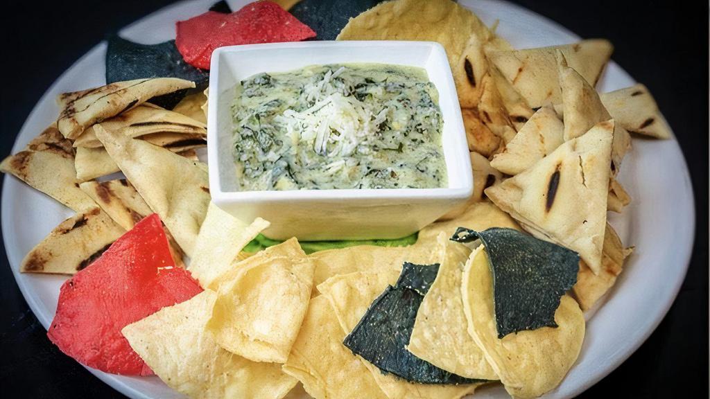 Spinach & Artichoke Dip · Roasted artichoke, creamy spinach and brie dip with tortilla chips and grilled flatbread.