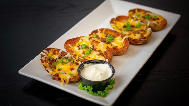 Potato Skins · Smashed potatoes with cheddar, bacon, and green onions.