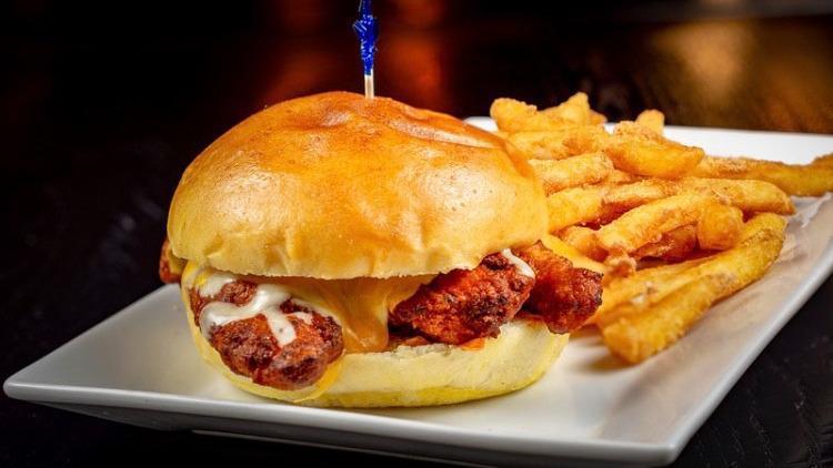 Chicken Tender Melt Sandwich · Served fried, tossed in your choice of wing sauce, topped with melted cheddar-jack cheese. Choice of blue cheese or ranch dressing.