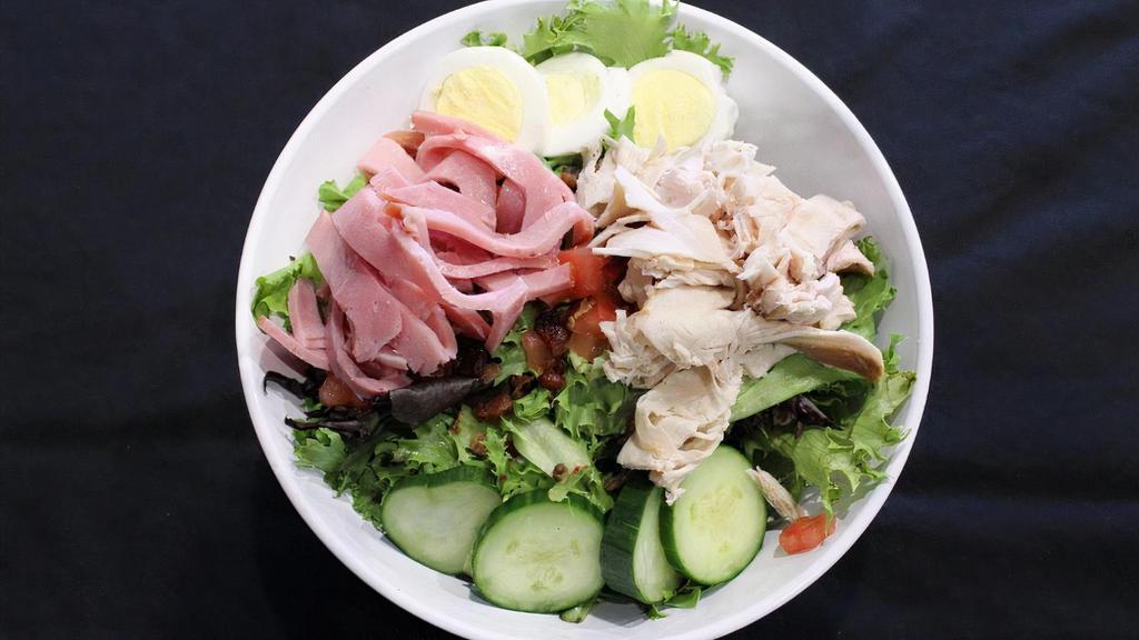 Chef Salad · Fresh greens topped with ham, turkey, bacon, hard boiled egg, cheddar-jack, diced tomatoes, and cucumbers