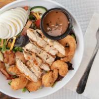 Shrimp & Chicken Cobb Salad · Fresh greens, topped with fried shrimp and grilled chicken, hard boiled egg, cheddar-jack ch...
