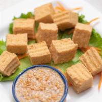 12 Piece Golden Fried Tofu · Served with a sweet and sour sauce, topped with ground peanuts.