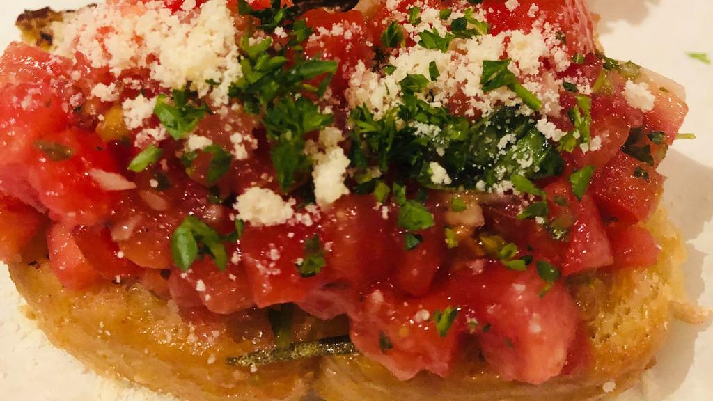 Bruschetta · Toasted ciabatta bread topped with fresh diced tomatoes, garlic, basil, and a drizzle of extra-virgin olive oil.