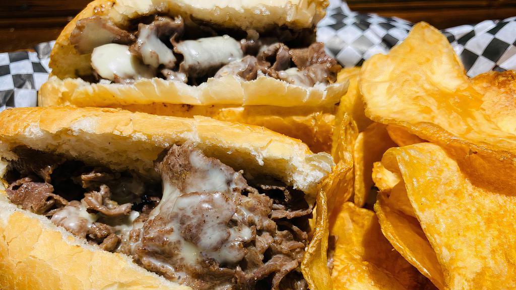 Cheese Steak · Thinly sliced grilled rib-eye steak with melted cheese .Served on a soft Italian roll with our house-made chips.